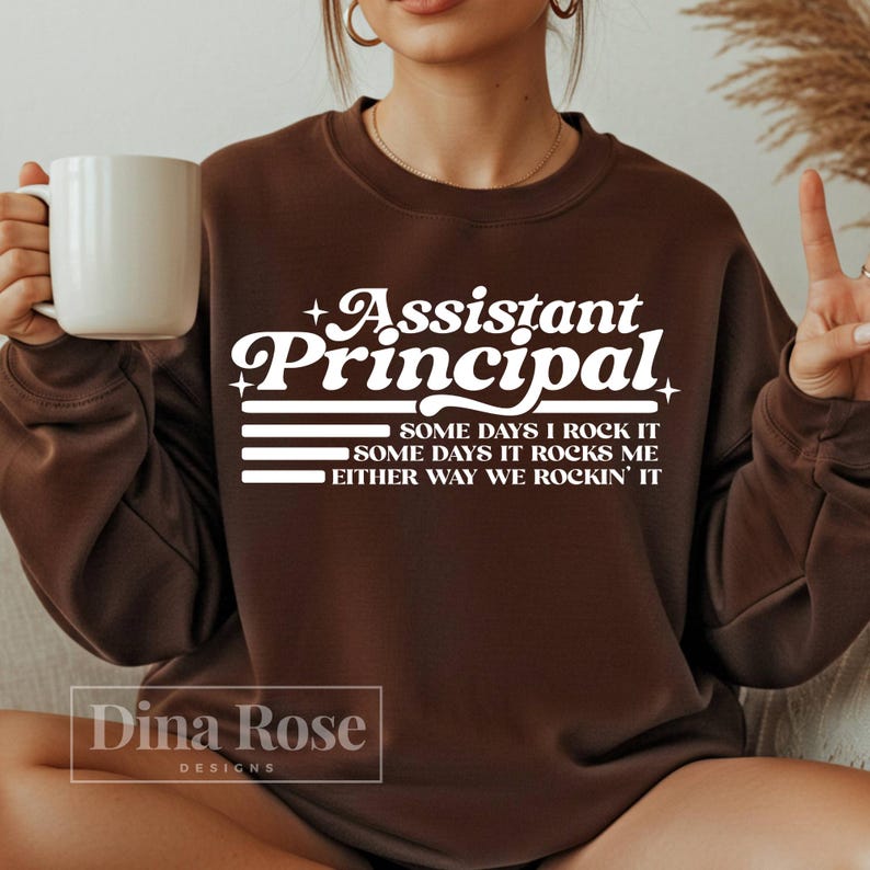 May include: A white ceramic mug with a black handle and the text "But First, Coffee" in a black, bold font. The mug is on a white surface.