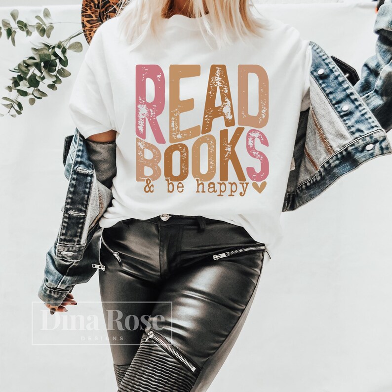 May include: White t-shirt with the text "READ BOOKS & be happy" in pink and brown lettering with a pink heart.