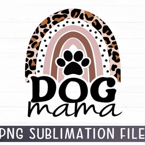 May include: A digital design featuring a rainbow with a paw print in the center. The rainbow is made up of brown, pink, and white stripes. The rainbow is surrounded by a leopard print pattern. The text "Dog mama" is written below the rainbow.