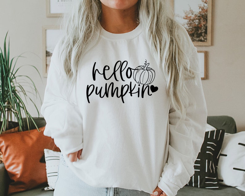 May include: White sweatshirt with the text "hello pumpkin" in black script font, a small pumpkin graphic, and a black heart.