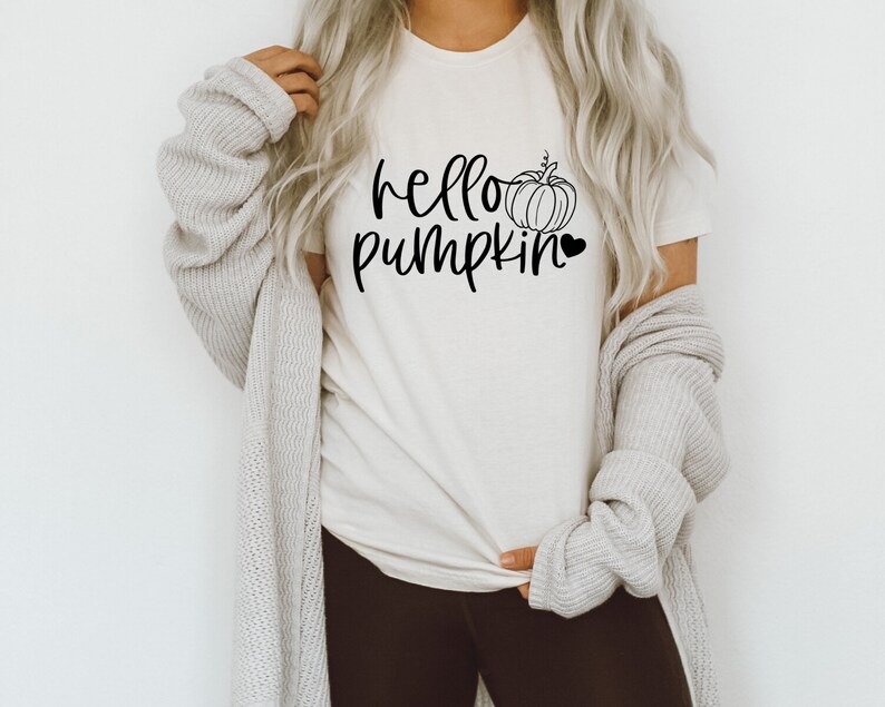 May include: A white t-shirt with the text "hello pumpkin" and a small pumpkin graphic with a heart.