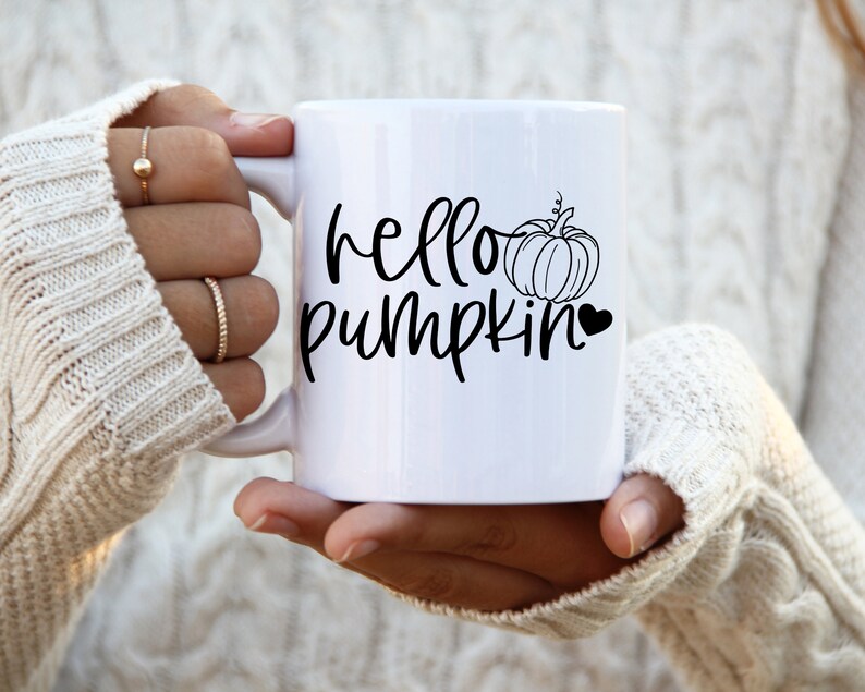 May include: White ceramic mug with a black design that says "hello pumpkin" with a small pumpkin and heart graphic.