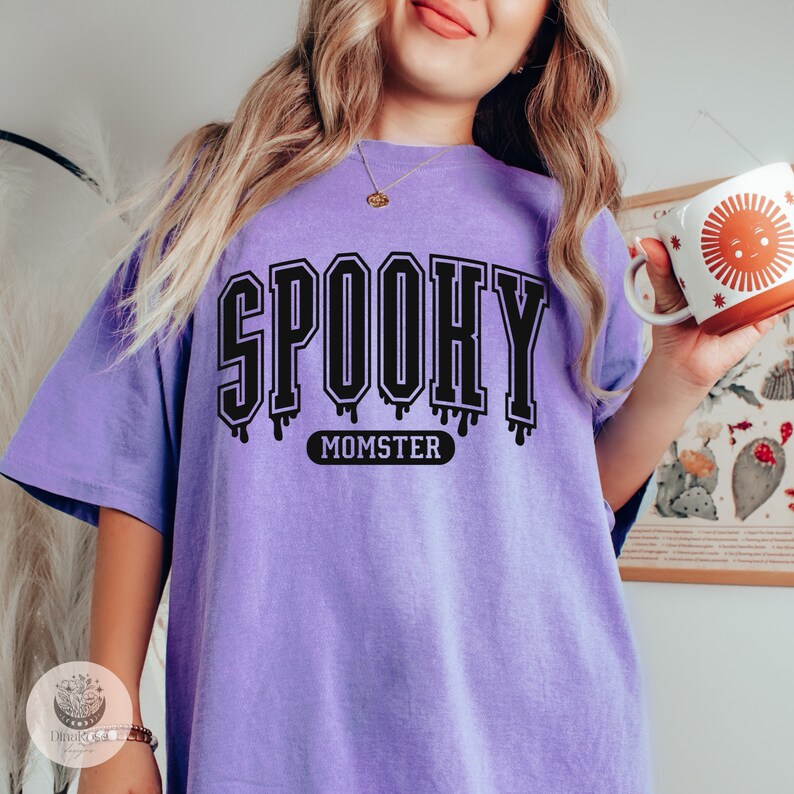 May include: Purple t-shirt with the text "SPOOKY MOMSTER" in black dripping letters.