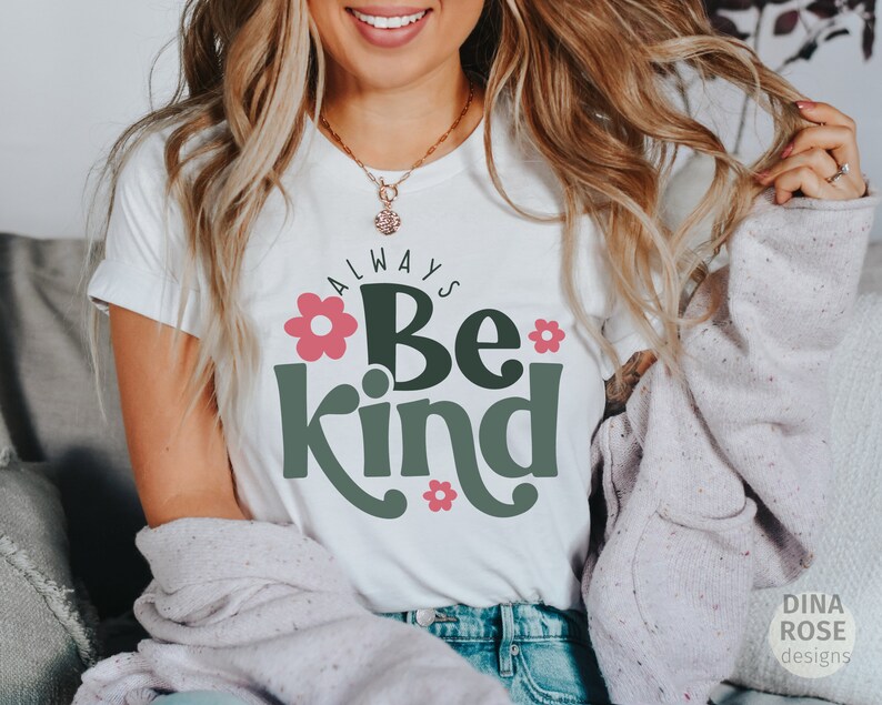 May include: White t-shirt with the text "Always Be Kind" in green letters with pink flowers.