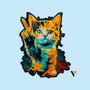 May include: A colorful embroidered patch featuring a calico kitten with large eyes, raising one paw in a peace sign gesture. The design uses vibrant shades of orange, teal, and black with a thick black border, creating a high-contrast graphic.