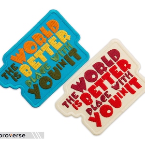 May include: Two embroidered patches with the text "The world is better place with you in it". The patch on the left is blue with orange, yellow, and green text. The patch on the right is white with red, orange, and yellow text.