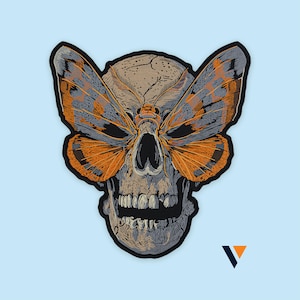 May include: A detailed illustration of a skull with a moth design. The moth's wings are orange and gray, and the skull is tan with black accents. The design is set against a light blue background.