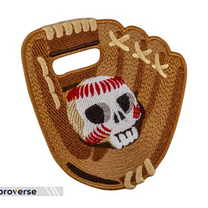 May include: A brown leather baseball glove with a white skull and red stitching on the baseball inside the glove.