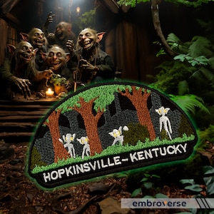 May include: A green, black, and brown embroidered patch with the text "HOPKINSVILLE - KENTUCKY" and a depiction of a forest with three trees and four small, white, alien-like figures.
