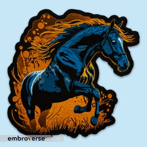 May include: Embroidered patch featuring a prancing black horse with blue highlights and flowing orange mane. The horse is set against an orange and black background with the word "embroverse" at the bottom. The patch has a black border.
