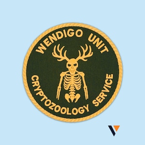 May include: A round patch with the text "WENDIGO UNIT CRYPTOZOOLOGY SERVICE" in yellow lettering. The patch features a yellow skeleton with antlers on a dark green background, surrounded by a yellow border.