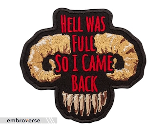 May include: Black embroidered patch with a red embroidered phrase "Hell was full so I came back" and two gold embroidered horns.