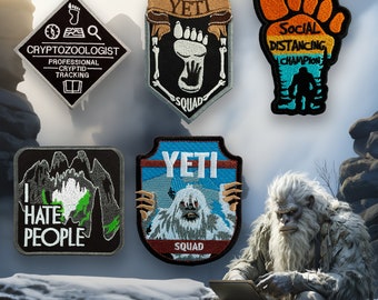 May include: Five embroidered patches featuring various designs, including a Yeti, a footprint, a mountain range, and a social distancing champion. The patches are all on a gray background with a Yeti figure in the foreground.