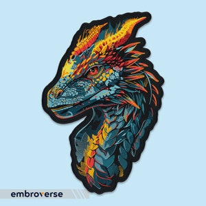 May include: A colourful embroidered patch of a dragon's head with blue, green, yellow, and red scales. The dragon's head is facing left and has a sharp, pointed snout.