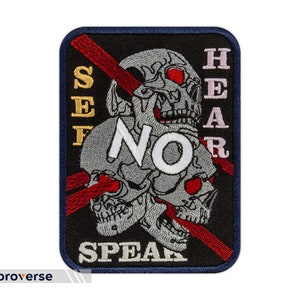 May include: Black embroidered patch with three skulls and a red slash through them. The text "See No Hear No Speak" is embroidered in gold, white, and pink.