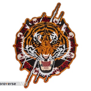 May include: A fierce tiger's face embroidered on a black background, surrounded by a circle of red and white skulls and floral designs. The tiger's face is orange and black with white stripes and a menacing expression.