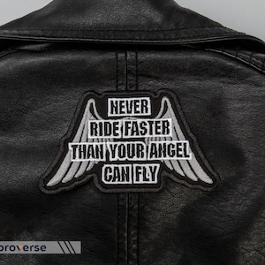May include: Black leather jacket with a white embroidered patch that says "Never ride faster than your angel can fly" with wings on either side.