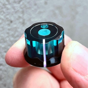 Perilla giratoria turquesa transparente / negra opaca