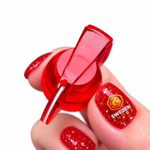 May include: A translucent red plastic control knob with a pointer arm and a circular base. The knob features a smooth, glossy finish and a distinct shape designed for adjustment. The design is simple, functional, and made of clear red material.