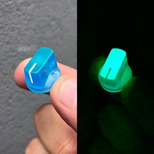 May include: A light blue knob with a white line down the center. The knob glows green in the dark.