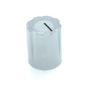 May include: A translucent, cylindrical control knob featuring a fluted, scalloped edge along the top rim. The top surface is flat and includes a single, thin, black indicator line that extends from the center toward the outer edge for alignment.
