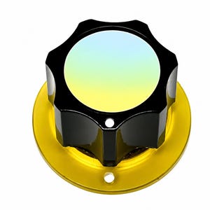 May include: A circular control knob featuring a glossy black, multi-faceted exterior with a smooth, iridescent center that transitions from pale blue to yellow. The knob is mounted on a flat, circular, metallic gold base with two small holes.