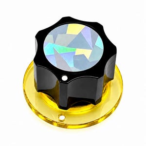Grote gitaar-/synthesizerknop met holografische toplaag met sterren - transparant geel / ondoorzichtig zwart - diameter 2,5 cm