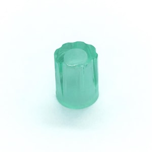 May include: A translucent mint green cylindrical knob featuring a fluted exterior design with vertical ridges and a smooth, flat circular top surface. The object is constructed from a clear, glass-like material with a consistent light green hue.