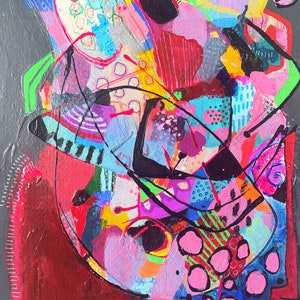 May include: Abstract painting with a colourful, layered design. The painting features a mix of geometric shapes, lines, and dots in shades of pink, blue, green, yellow, black, and red. The background is a dark grey.