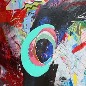 May include: Abstract painting with a large black shape in the center. The shape has a turquoise circle with pink and white rings inside. The background is a mix of red, blue, green, and yellow.