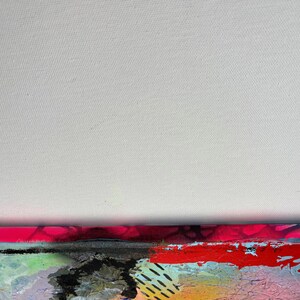 May include: Abstract painting on canvas with a mix of bright colors, including pink, red, yellow, blue, and green. The painting has a textured surface and appears to be made with multiple layers of paint.