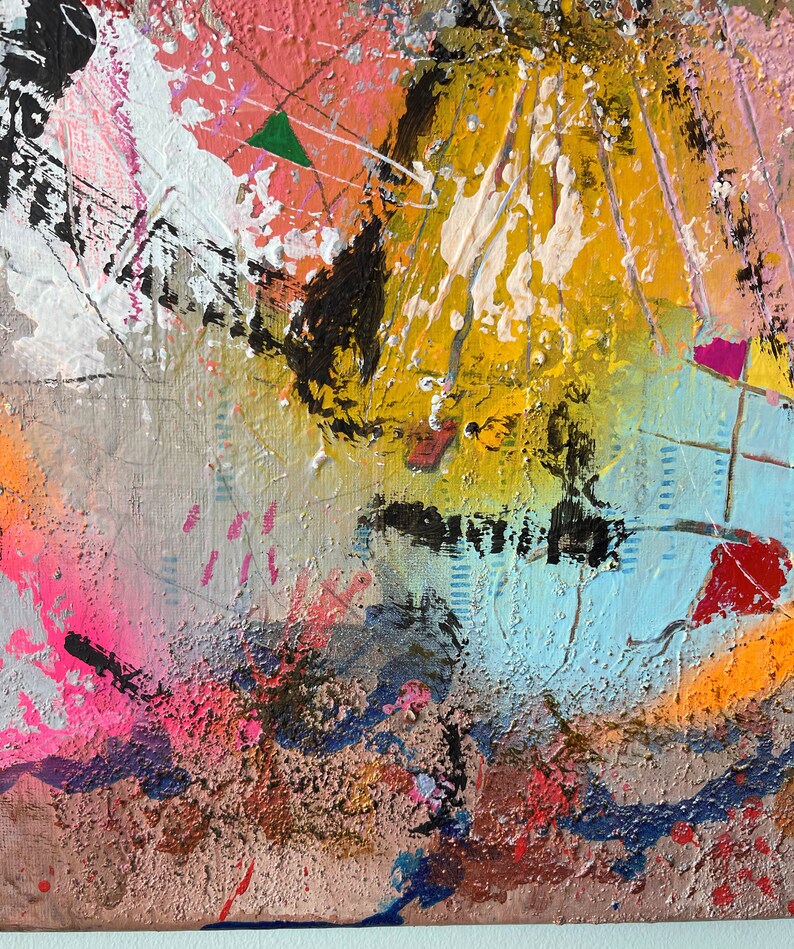 Op de afbeelding: Abstract schilderij met een mix van kleuren, waaronder roze, geel, blauw, zwart en wit. De verf is aangebracht in een dikke, textuurrijke stijl, wat een dynamische en energieke compositie cre&euml;ert.