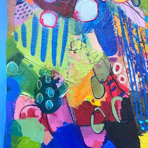 May include: Abstract painting featuring a vibrant mix of colours, including blue, green, yellow, red, and pink. The painting incorporates a variety of shapes and textures, creating a dynamic and energetic composition.