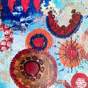 May include: Abstract painting with a blue background and colourful circles with different patterns. The circles are painted in shades of red, orange, brown, and white.