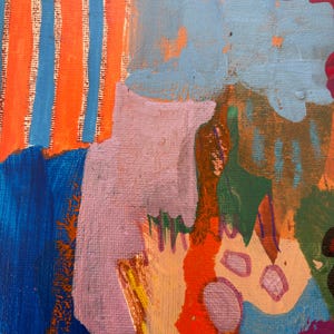 May include: An abstract painting on canvas featuring a vibrant composition of colors including orange and blue vertical stripes, a large light purple shape, patches of deep blue, bright red, soft pink, and dark green, with visible brushstroke textures.