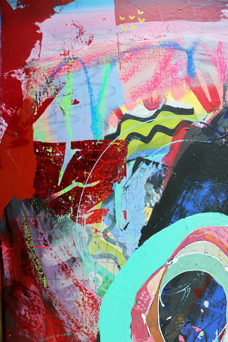 May include: Abstract painting with bold strokes of red, pink, blue, green, and black paint. The painting features a large, circular shape in the lower right corner, with concentric rings of color.