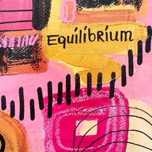 May include: Abstract painting with pink, yellow, black, and white paint. The painting features geometric shapes and lines. The word "Equilibrium" is written in black paint on a yellow background.