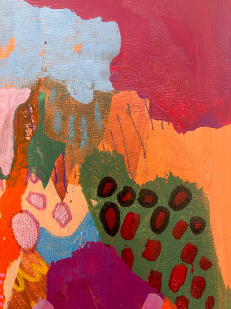 May include: An abstract painting on canvas featuring a vibrant composition of layered shapes and colors. The artwork displays bold sections of magenta, bright orange, light blue, and olive green, accented by dark red circular and oval markings.