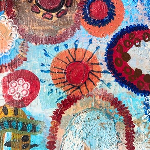 May include: Abstract painting with a blue background and colourful circles, dots, and swirls. The circles are in shades of red, orange, brown, and white.