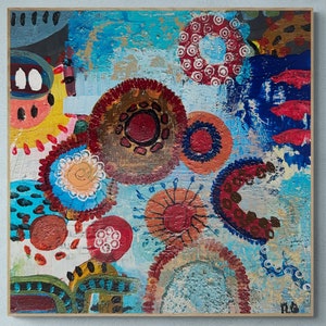 May include: Abstract painting with a blue background and colourful circles, dots, and swirls. The painting is framed in a wooden frame.