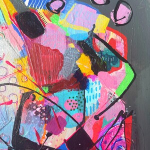 May include: Abstract painting featuring vibrant colours, including pink, blue, green, yellow, and black. The painting incorporates geometric shapes and lines, resulting in a dynamic and energetic composition.