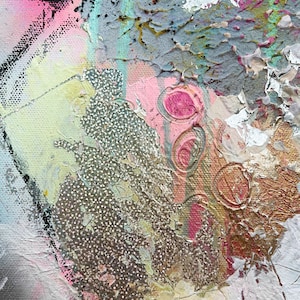May include: Abstract painting with a textured surface. The painting features a variety of colors, including pink, gold, and white. The paint is applied in a thick, layered style, creating a sense of depth and dimension.