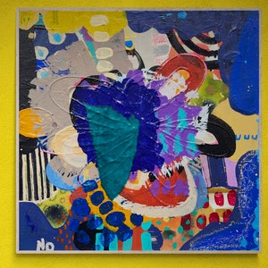 May include: Abstract painting with a colourful, layered design. The painting features a variety of shapes and colours, including blue, purple, green, yellow, and red. The painting is framed and has a white border.