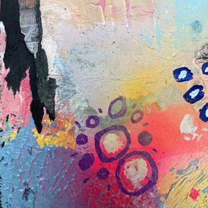 May include: Abstract painting with a colorful background of pink, blue, yellow, and red. The painting features purple circles and lines.