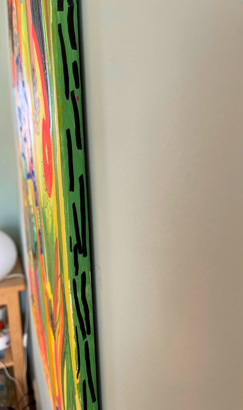 May include: A colorful abstract painting with a green background and black lines along the edge. The painting has a variety of colors, including yellow, orange, red, and blue.