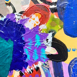 May include: Abstract painting with bold strokes of blue, purple, red, yellow, and green paint. The painting has a textured surface and a variety of shapes and patterns.