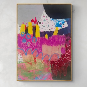 May include: A rectangular painting in a thin gold frame featuring abstract layers of paint. The composition includes vibrant yellow vertical strokes, bright pink textured areas, blue circular outlines, a black shape, and a white section with multicoloured confetti-like flecks.