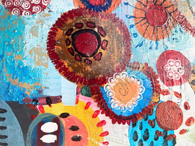May include: Abstract painting with a blue background and colourful circles, some with white dots and others with black outlines.