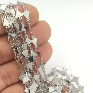 May include: Silver triangle chain with a shiny finish. The chain is made of small, interconnected triangles.
