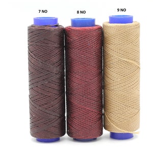 May include: Three spools of waxed thread in brown, burgundy, and beige colours. The spools are labelled 7 NO, 8 NO, and 9 NO.